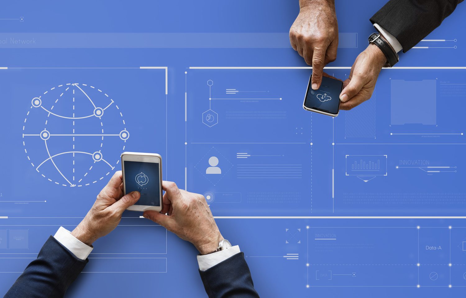 Blue table with two peoples hands checking phones