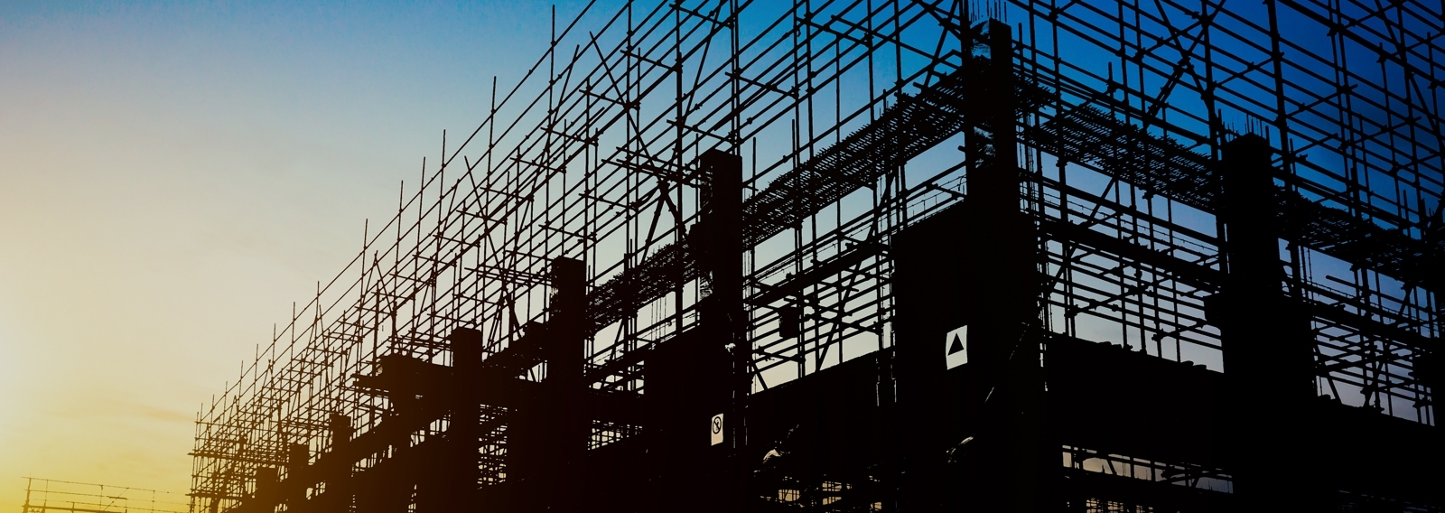 Construction side scaffolding with sunrise in background